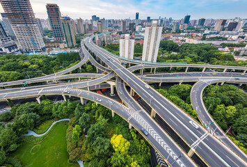 Aerial view of complex highway interchange with buildings in Shanghai