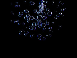 Close-up of blue bubbles underwater. Underwater oxygen design concept.