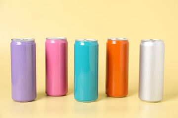 Many colorful tin cans on beige background
