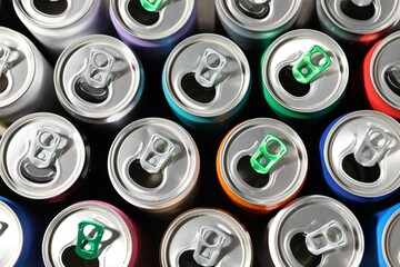 Many aluminium cans of beverage as background, top view