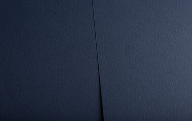 Navy blue paper background with a matte, fibrous texture and subtle perforated details. Deep, rich...