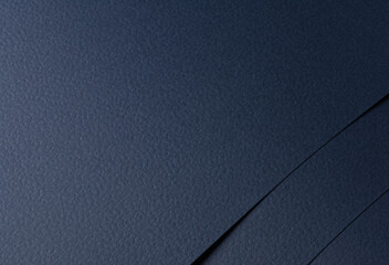 Navy blue paper background with a matte texture and rough grain. Deep, dark tones create an...