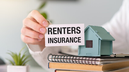 Businessman holding a card with text Renters Insurance, Business Concept