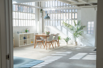 Interior design of a industrial loft dinning room, table, and chairs in a living room. High quality photo
