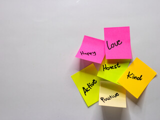 Some sticky notes with positive words written on a white background. Motivational word photo concept.
