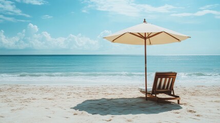 Fototapeta premium Beach scene with umbrella and chair