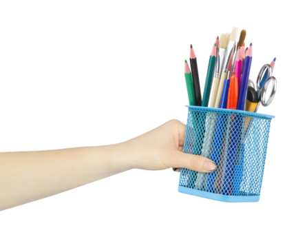 Colored pencils and various school supplies in a metal holder or cup in hand, outstretched hand with pen stand isolated from background