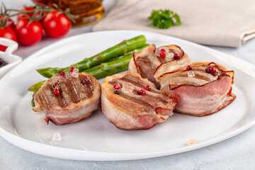 Tasty grilled pork medallion with bacon