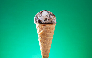 Ice cream cone with colorful sprinkles on red background. Close up.