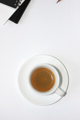 Cup of Espresso Coffee on White Background with Notebooks, Papers, Stationery. Minimal Workplace Setup with Coffee. Coffee Break.
