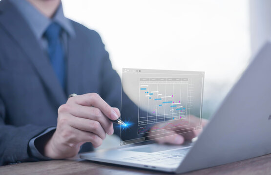 Marking schedule concept. Businessman using laptop create a calendar program virtual, rganize and schedule activity and event planner, a calendar page shows on laptop, scheduler, date appointing