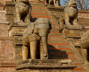  Elephant and dog carved stone on the steps up to a Buddhist Temple