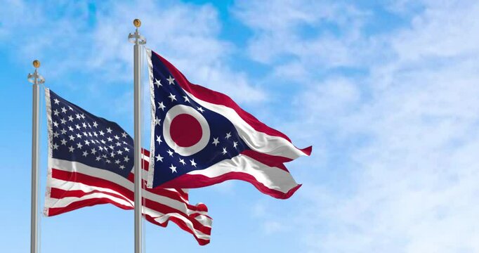 Ohio and national US flags waving in the wind on a clear day