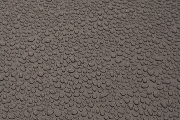 Background - raindrops on the metal surface of a modern car