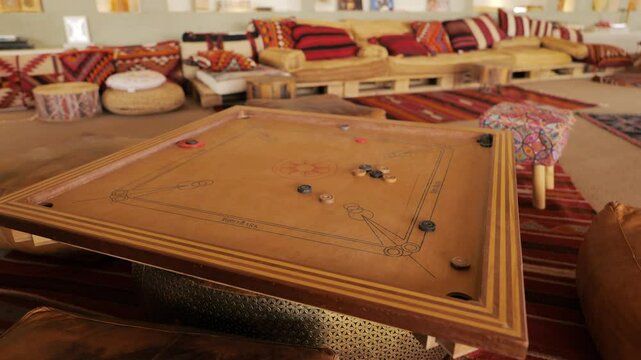 Traditional Carrom Board Game in a Cozy Arabic Lounge. Video.