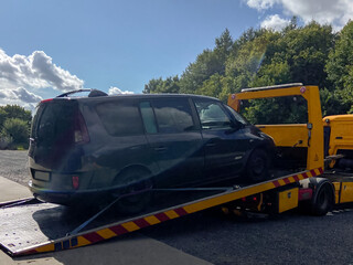 Car on tow truck, loaded for transport, outdoors view