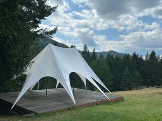 Modern White Canopy Tent in a Scenic Mountain Landscape