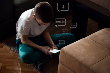 Boy sitting on floor at looking at smart phone feeling frustrated after reading bad message.