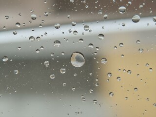 Ephemeral Water Droplets: Capturing the fleeting beauty of water droplets clinging to a surface, reflecting a blurred cityscape in their transparent spheres.