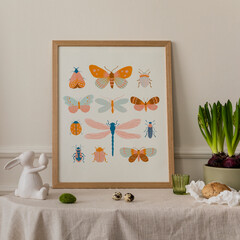 Cozy composition of easter living room interior with mock up poster frame, sideboard, easter bunny, Hyacinth, stylish bowl, eggs and personal accessories. Home decor. Template.
