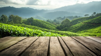 Naklejka premium Wooden table overlooking a beautiful green tea plantation in the mountains