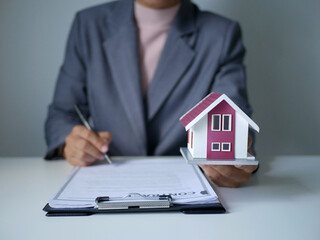 Fototapeta premium Real estate agent explains home rental and home insurance. Rent, Buy, Home Insurance, Home Insurance Concept