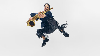 Jumping saxophonist mid-air, face full of excitement, striking rockstar pose while playing golden...