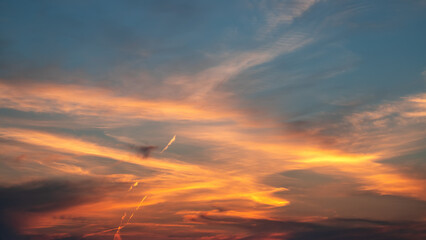 Awesome sunset and soft pink clouds of pastel tones. Image template of textured sky. Bright epic sky. Dramatic evening light and fiery orange sunset.