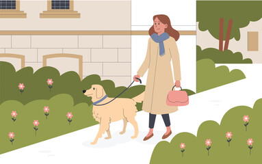 Fototapeta premium Smiling woman walks dog outdoors