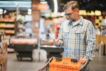 Senior man at grocery store products