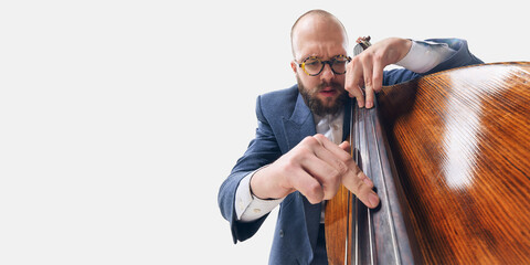 Close-up of man in glasses, jazz musician focusing on bass strings, deeply immersed in rhythm and...