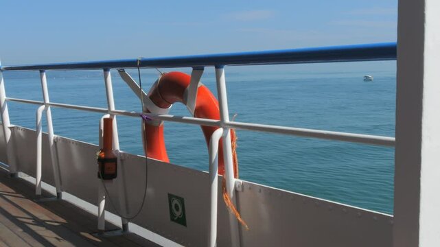 Scenic View from a Ferry with a Lifebuoy Overlooking the Calm Sea