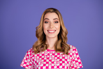 Smiling young woman in stylish patterned shirt against vibrant purple background