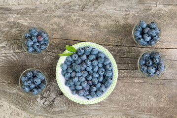 Top view of fresh blueberries in a bowl on wooden table