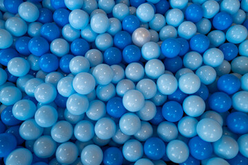 Blue ball. Close up of plastic balls in a kids ball pool. Kids playground. Recreation and entertainment concept. Colorful kid blue ball. Colorful blue ball at the playground.