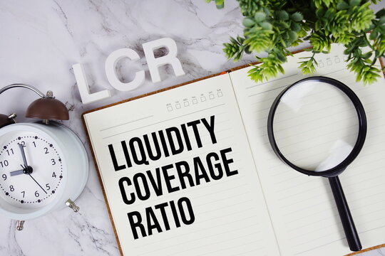 LCR- Liquidity Coverage Ratio acronym on notepad, Business concept background