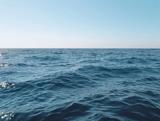 Fototapeta premium Bright blue ocean, endless horizon, calm water, and blue sky