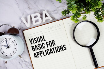 VBA - Visual Basic for Applications acronym on notepad, Financial concept background