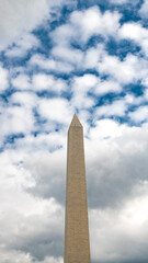 Washington Monument against a cloudy sky.