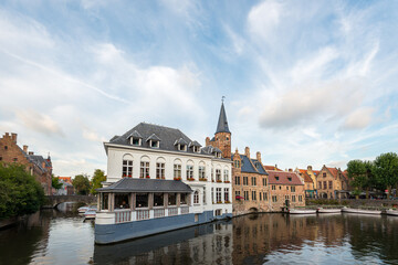 Brugge canals reflect charming architecture and serene atmosphere on a clear day