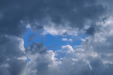 Summer evening sky in the picturesque clouds, lit by the rays of the setting sun.