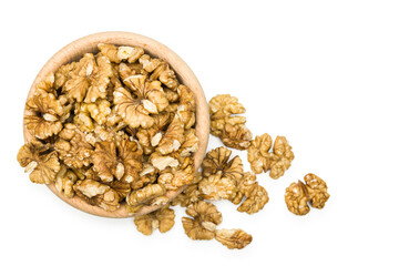 Top view of shelled walnuts into wooden bowl on white background.