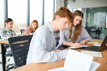 Fototapeta premium Students studying in library or classroom