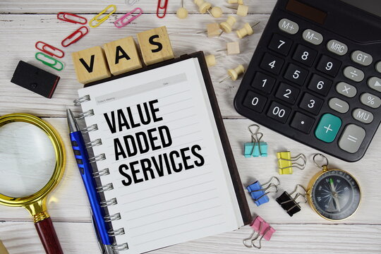 VAS - Value Added Services acronym on notepad, business and financial concept background