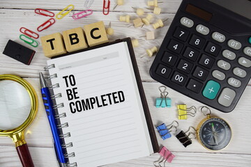 TBC - To Be Completed acronym on notepad, business and financial concept background