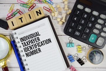 ITIN - Individual Taxpayer Identification Number acronym on notepad, Business and Financial concept background