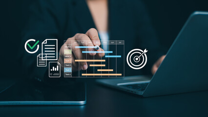 Project management tool and work schedule concept, Planning software, Businessman use laptop to...