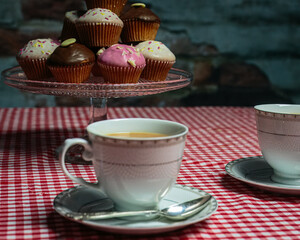 Cup of Tea and Cup Cakes on Gingham Table Cloth