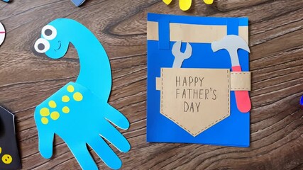 Crafting a colorful father's day card with fun dinosaurs and creative hand shapes. Happy Father's Day.