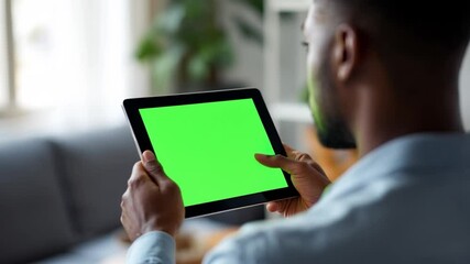 Close up view of man looking at tablet with green template display 4k Video. generated with AI